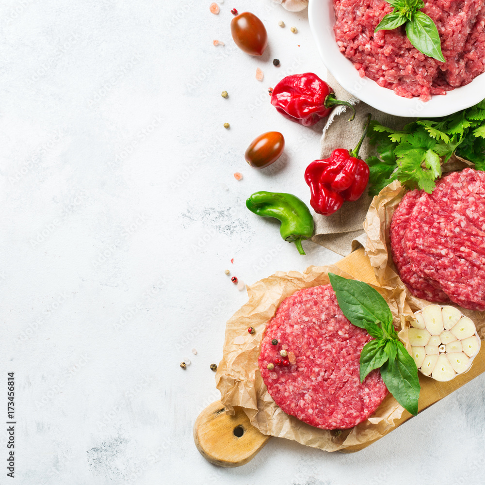 Homemade raw organic minced beef meat burger cutlet and vegetables Homemade raw organic minced beef meat burger cutlet and vegetables