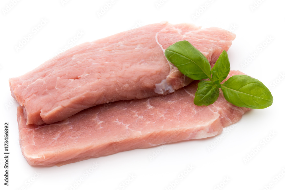 Fresh pork fillet with basil on a white background. Fresh pork fillet with basil on a white background.
