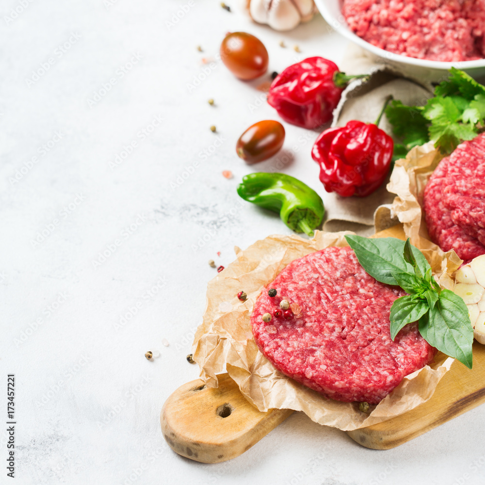 Homemade raw organic minced beef meat burger cutlet and vegetables Homemade raw organic minced beef meat burger cutlet and vegetables