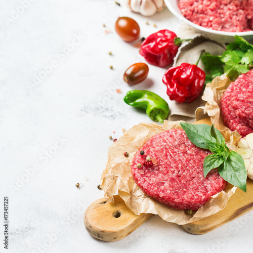 Homemade raw organic minced beef meat burger cutlet and vegetables