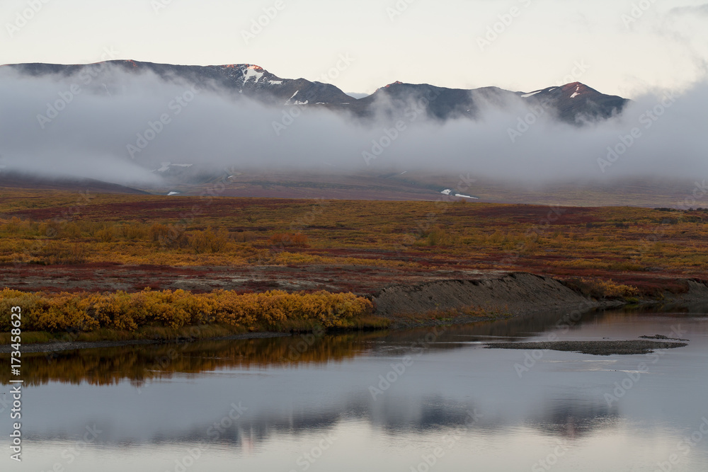 The river and the cloud at the foot of the mountains. Polar Urals. The Republic Of Komi. Russia.