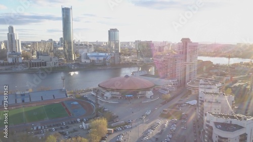 Aerial view city and sports palace. Modern city in sunset, aerial view of cityscape. Urban landscape photo