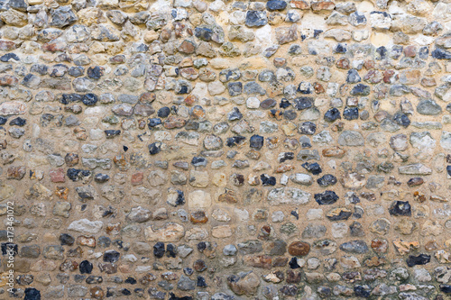 Background old brickwork with stones of different color
