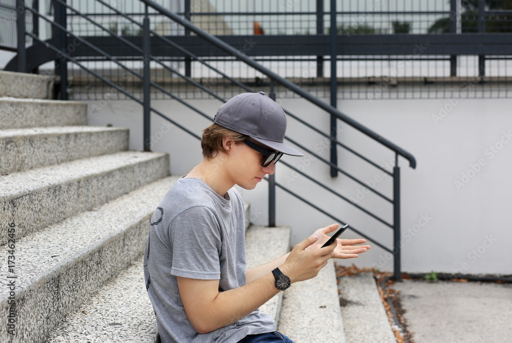 Attractive teenage boy in urban background Attractive teenage boy in urban background