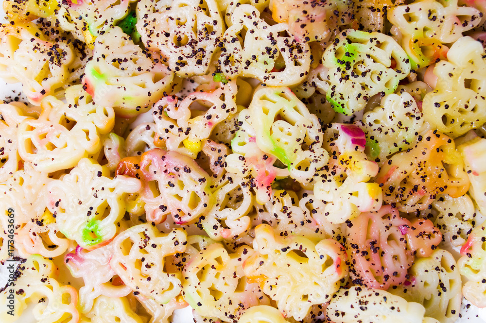 Colorful pasta with poppy seeds on a plate Colorful pasta with poppy seeds on a plate