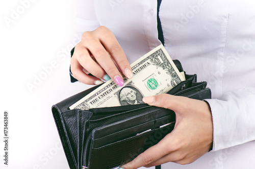  Businesswoman holding dollar banknotes isolated on a white background.Money in women's hands. American currency. One dollar banknotes in a wallet.