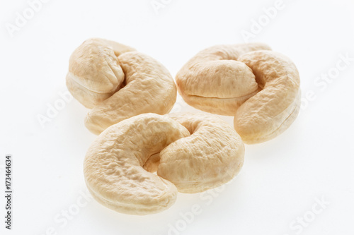 Cashew nuts heap peeled on a white background