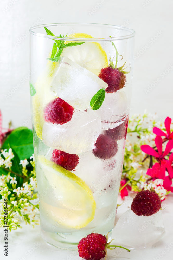 Raspberry in a glass with ice for making a juice Raspberry in a glass with ice for making a juice