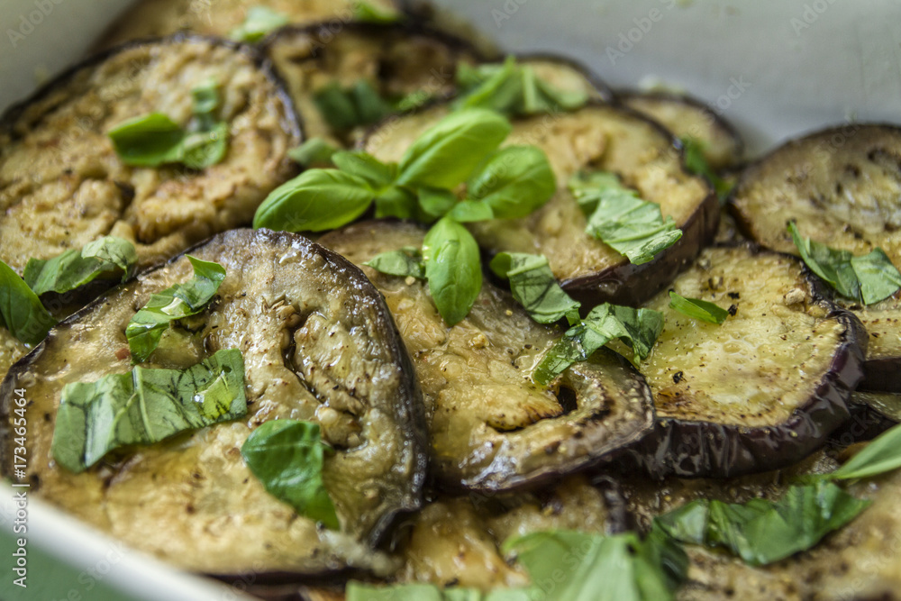 Fried and cooked aubergine with garlic basil in olive oil Fried and cooked aubergine with garlic basil in olive oil