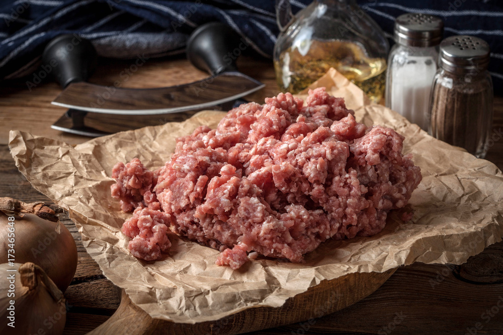 Minced meat on wooden background.