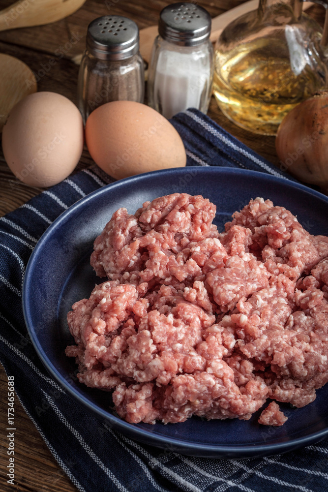 Minced meat on wooden background.
