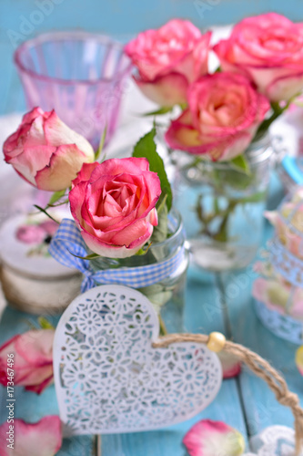 romantic table decoration with pink roses and white heart © teressa