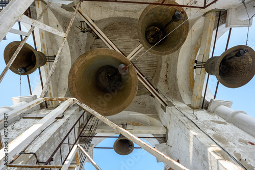 A number of different-sized bells in the Prepodobenskaya bell tower of the Rizopolozhensky female monastery. Suzdal, Golden Ring, Russia photo