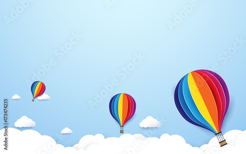 colorful hot air balloons flying on blue sky background. Paper art and craft style design