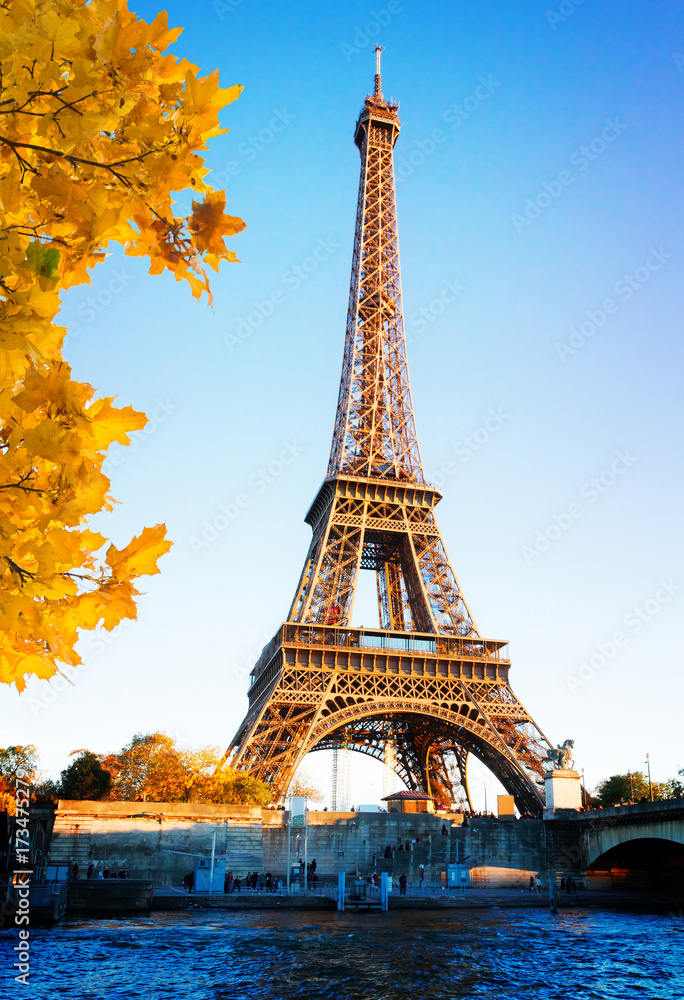 Eiffel Tower over Seine river in soft sunset light of autumn sun, Paris, France
