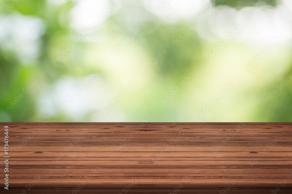 Wood table top on nature green blurred background,for montage your products Wood table top on nature green blurred background,for montage your products