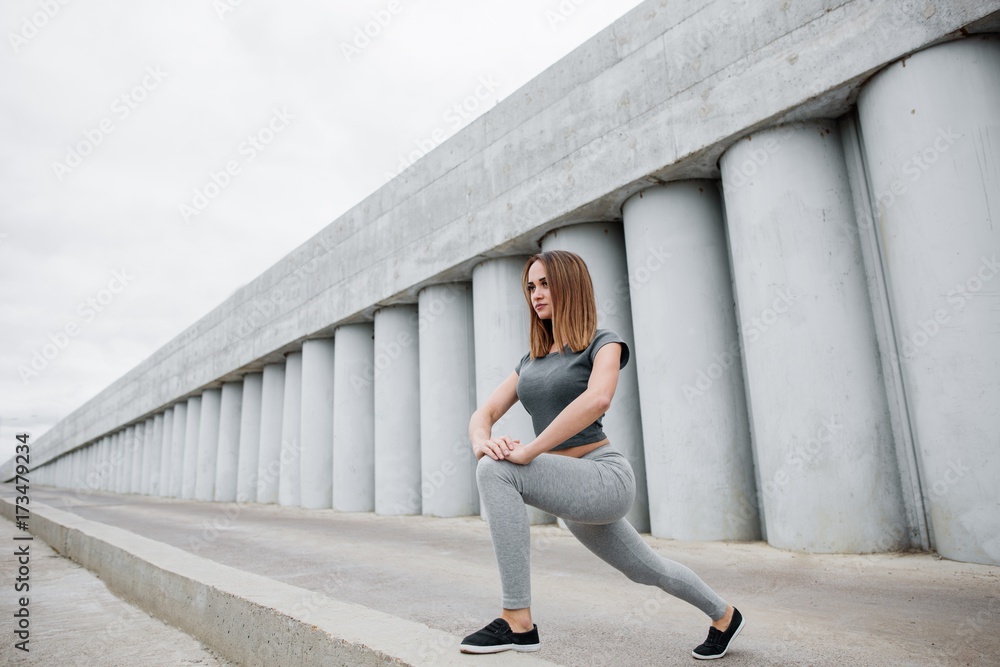 Fitness sport woman in fashion sportswear doing yoga fitness exercise in  the city street over black concrete background. Outdoor sports clothing and  s Stock Photo - Alamy
