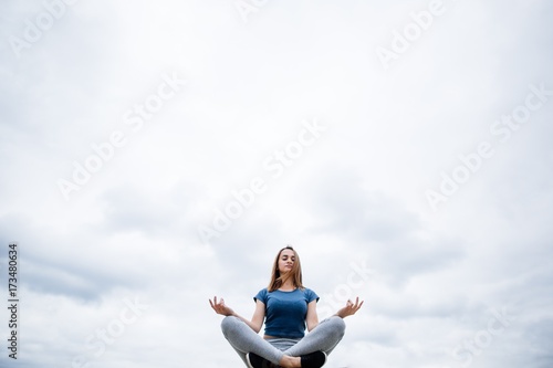 Girl does yoga in the sky