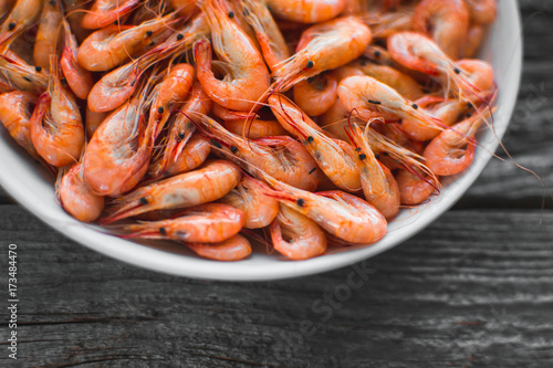 on a white plate on wooden background shrimp