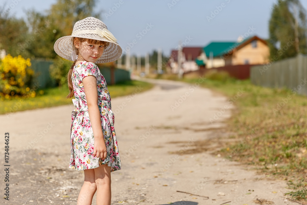 6-year-old girl standing on the road in the village