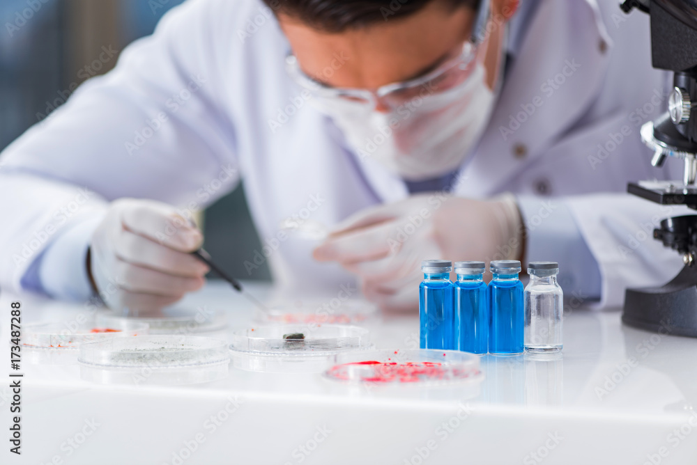 Male doctor working in the lab on virus vaccine Male doctor working in the lab on virus vaccine