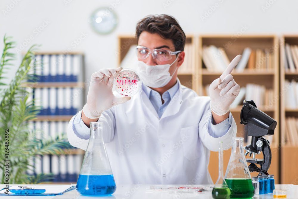 Male doctor working in the lab on virus vaccine Male doctor working in the lab on virus vaccine