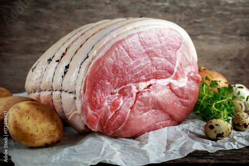 Fotografija Raw whole green gammon a piece with vegetable and eggs.