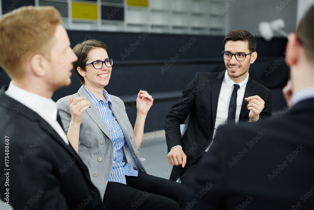 Team of professionals in formalwear discussing modern business trends and organizing new project Team of professionals in formalwear discussing modern business trends and organizing new project