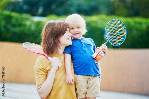 Little boy playing badminton with mom on the playground © Ekaterina Pokrovsky