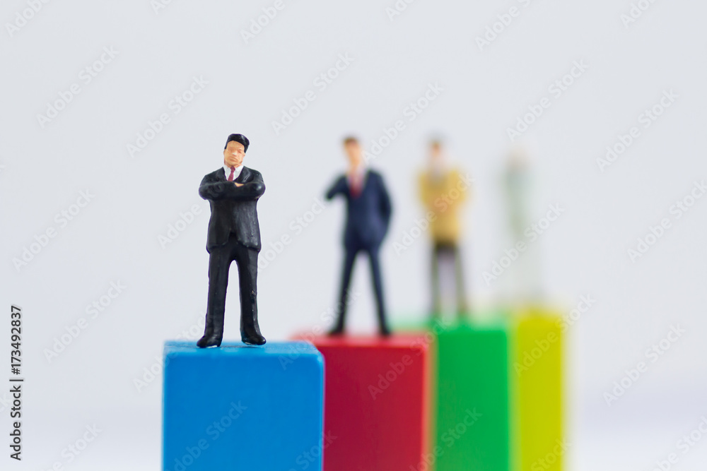 Miniature businessman :Graphs of various colors show the success of the work, Business teamwork concept. Miniature businessman :Graphs of various colors show the success of the work, Business teamwork concept.