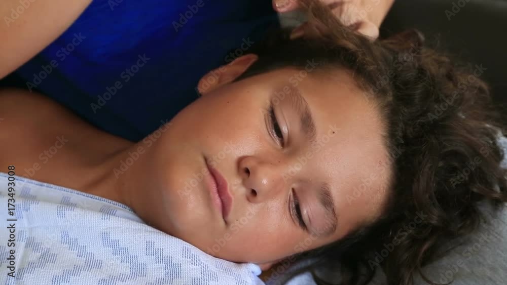 Mother treating son's hair against lice Mother treating son's hair against lice