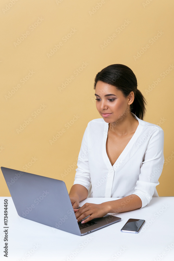 Woman in a white blouse working on a laptop at the office Woman in a white blouse working on a laptop at the office