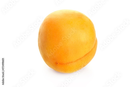 ripe juicy yellow apricot on white table
