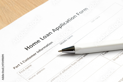 Home loan application form with pen on desk background