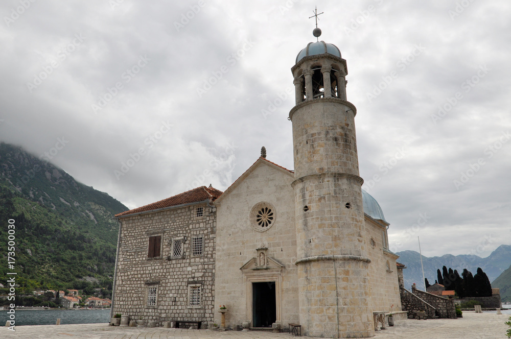 Fototapeta premium Arrival to the famous Our lady of the reef Island and Church in Kotor Bay of Montenegro