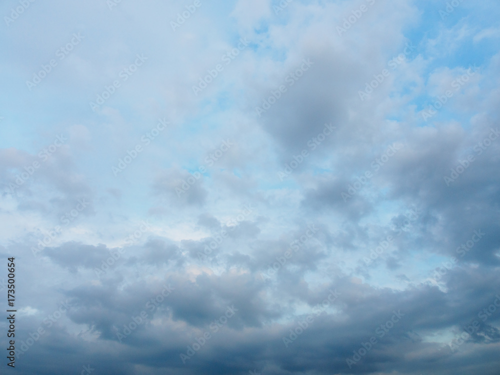 Wide angle view of a partially clear blue sky with dark cirrus and stratocumulus clouds, Thailand. Cloudscapes and weather concept.