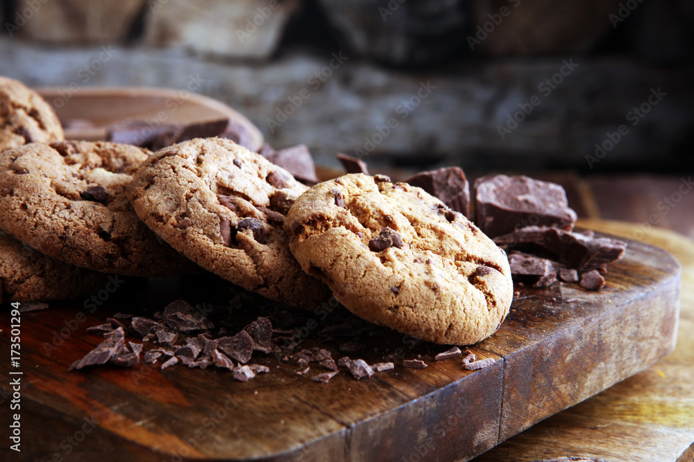 Fototapeta premium Chocolate cookies on wooden table. Chocolate chip cookies shot
