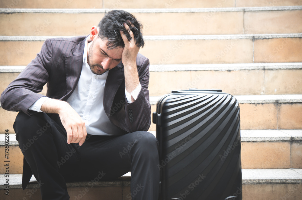 Business stress and sitting on stair with baggage in city outdoor Business stress and sitting on stair with baggage in city outdoor