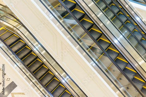 Escalator in Community Mall  Shopping Center. Moving up staircase. electric escalator. Close up to escalators. Close up floor platform. yellow bands. metal line steel. yellow gray steel line.