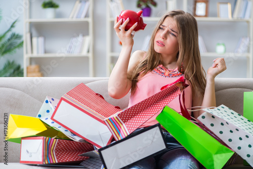 Canvas-taulu Young woman with shopping bags indoors home on sofa