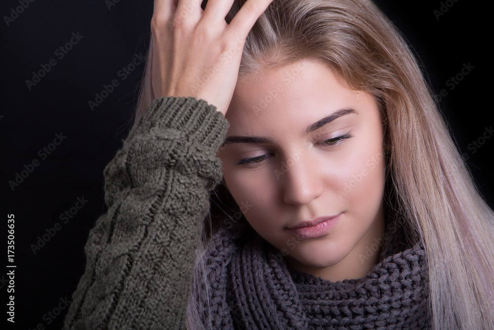 Portrait of a wooried teenager girl in sweater with multicolored hair Portrait of a wooried teenager girl in sweater with multicolored hair