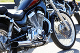 Crop view of motorcicle. Engine, front wheel, exhaust pipe. Shallow focus.