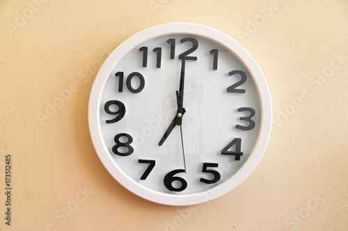 Wall clock on cream color background. 