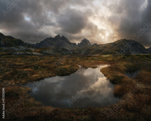 Little lake surrounded by mountains at sunset © inigocia