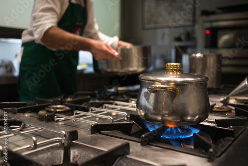 A chef cooking over the stoves