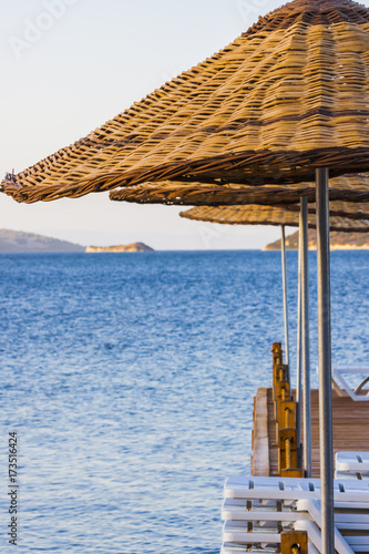 Wooden beach umbrellas at turkish aegean seaside: Cesmealti (Izmir - Turkey) photo