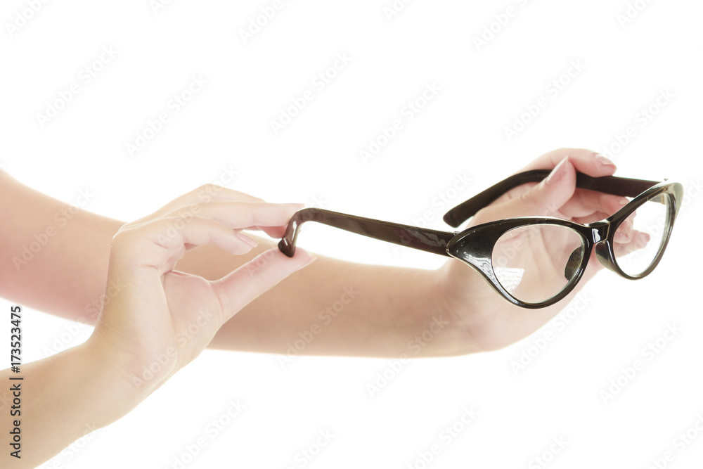 Woman hands holding retro black glasses Woman hands holding retro black glasses