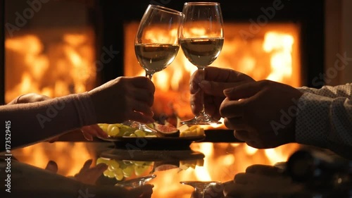Young couple have romantic dinner with wine over fireplace background. Romantic concept .