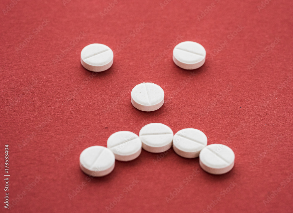Close-up of a heap of colourful pills on white background Close-up of a heap of colourful pills on white background