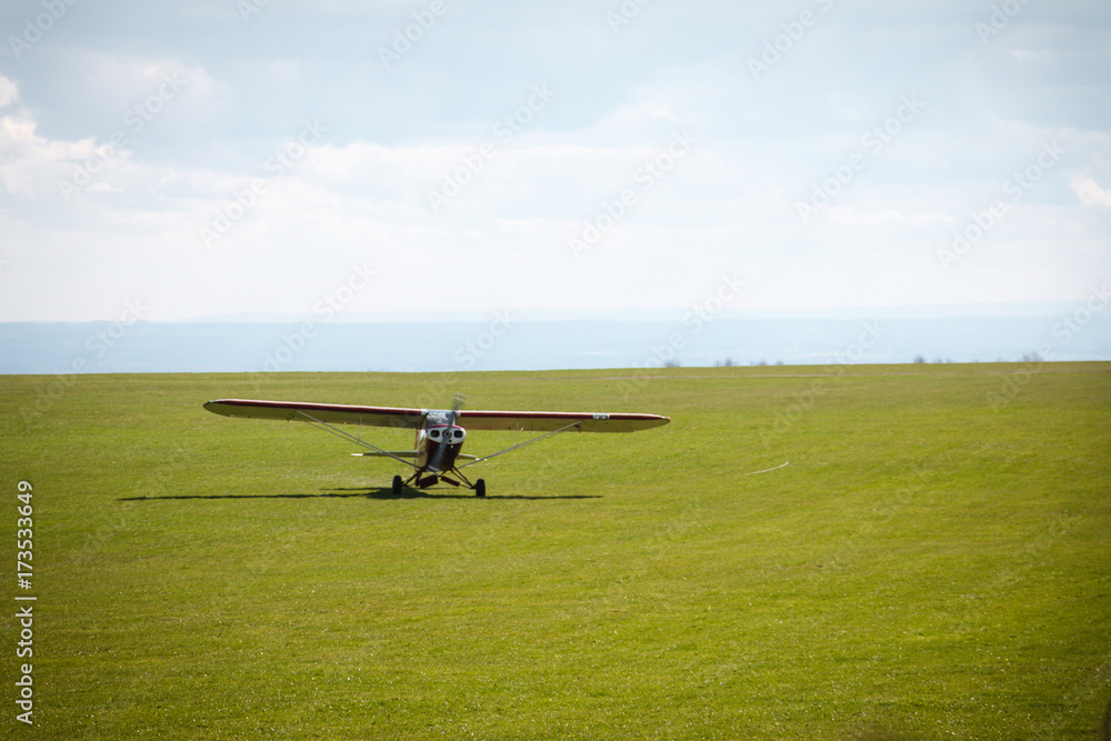 Small propeller airplane private towing aircraft on the contryside field England Small propeller airplane private towing aircraft on the contryside field England